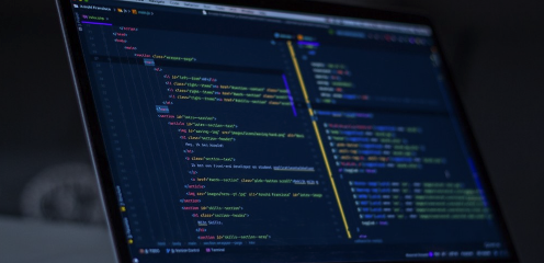 A close-up of a computer screen displaying lines of colourful code in a text editor or integrated development environment, indicating software development or programming work.